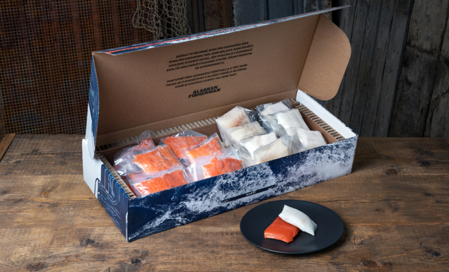 A big box of vacuum sealed portions of pacific cod and sockeye salmon